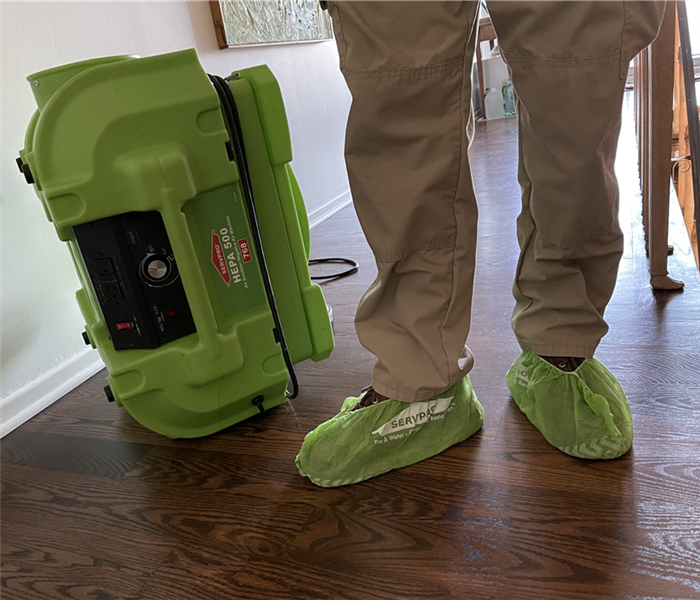 a man's feet with green shoe coverings