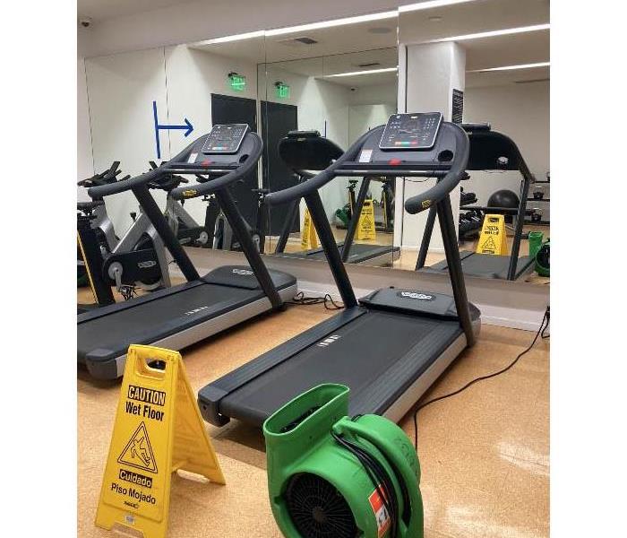 Apartment gym with air movers to dry water