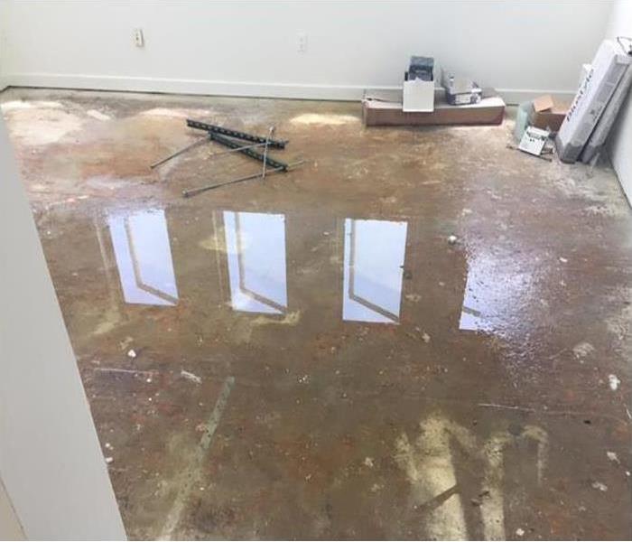 The floor of a room with standing water. Flooded room.